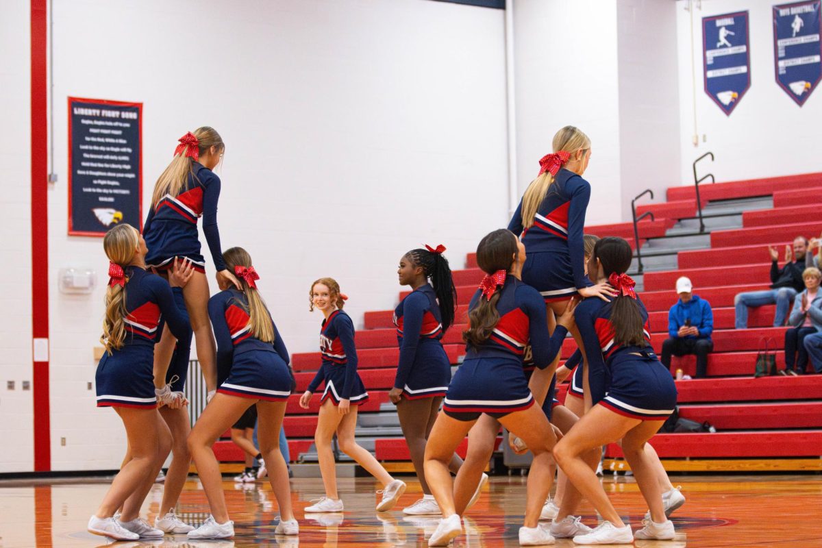 Freshman cheer team does a stunt during a halftime against Zumwalt West. 