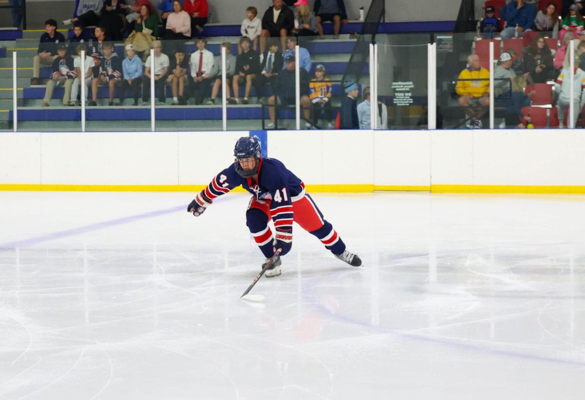 Nicholas Kuhn (11) skates around the ice after warm-ups before joining his team at the goal.