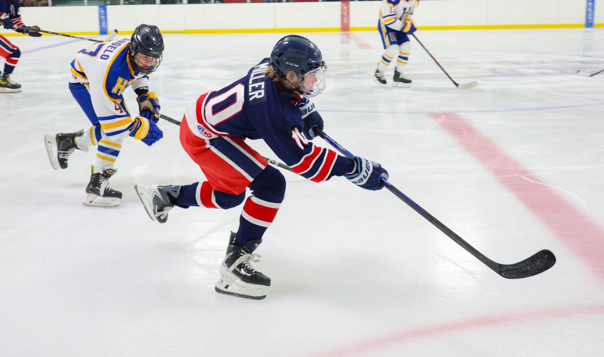 Leo Miller (9) skates down the ice with the puck in preseason game vs Francis Howell.