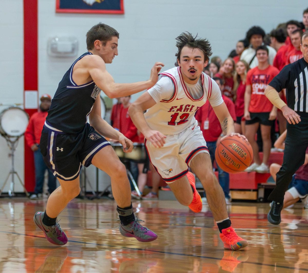 Tyler Cook (12) dribbles past the defender to get to the basket.