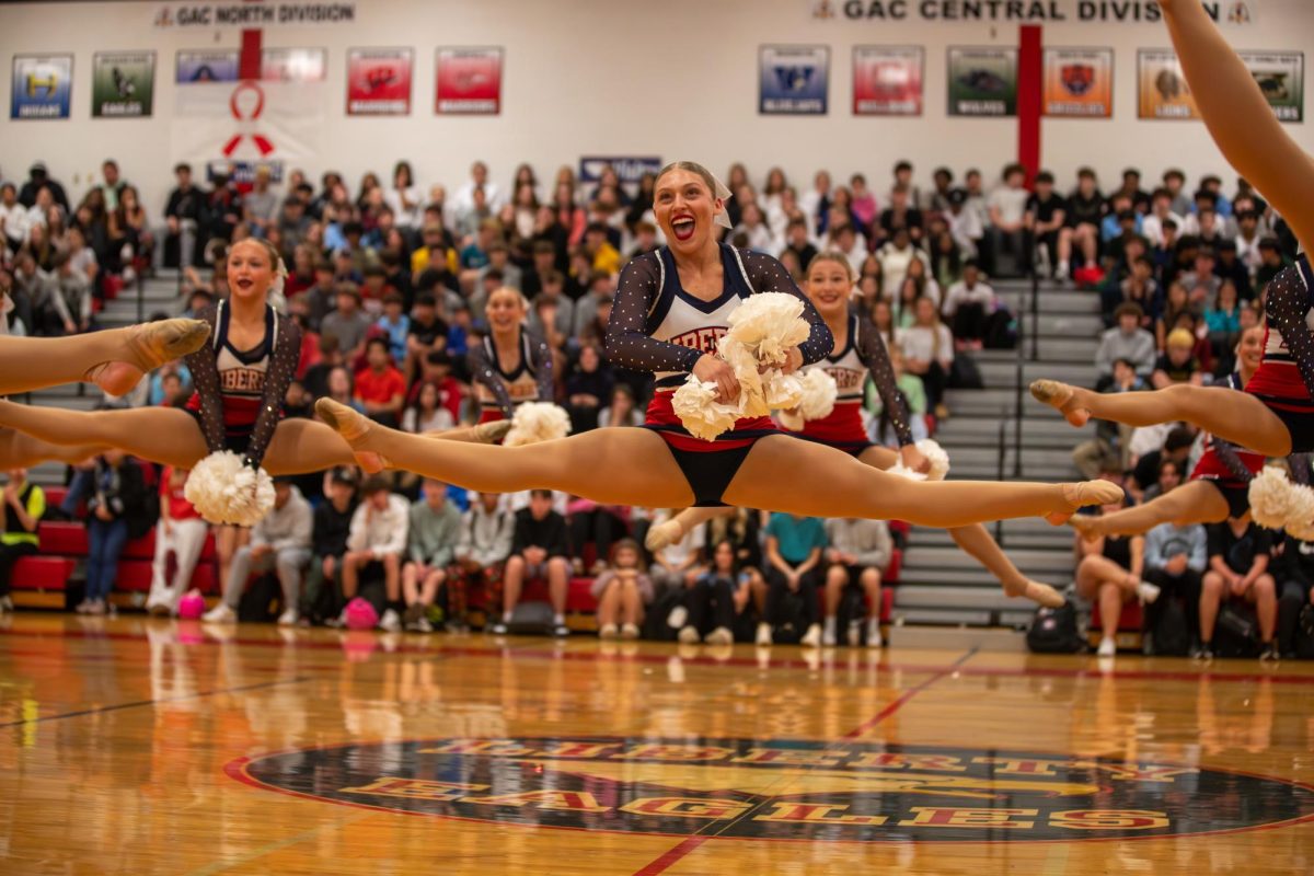 Myleigh Turnipseed (12) jumps high and proud during the Belles performance. 