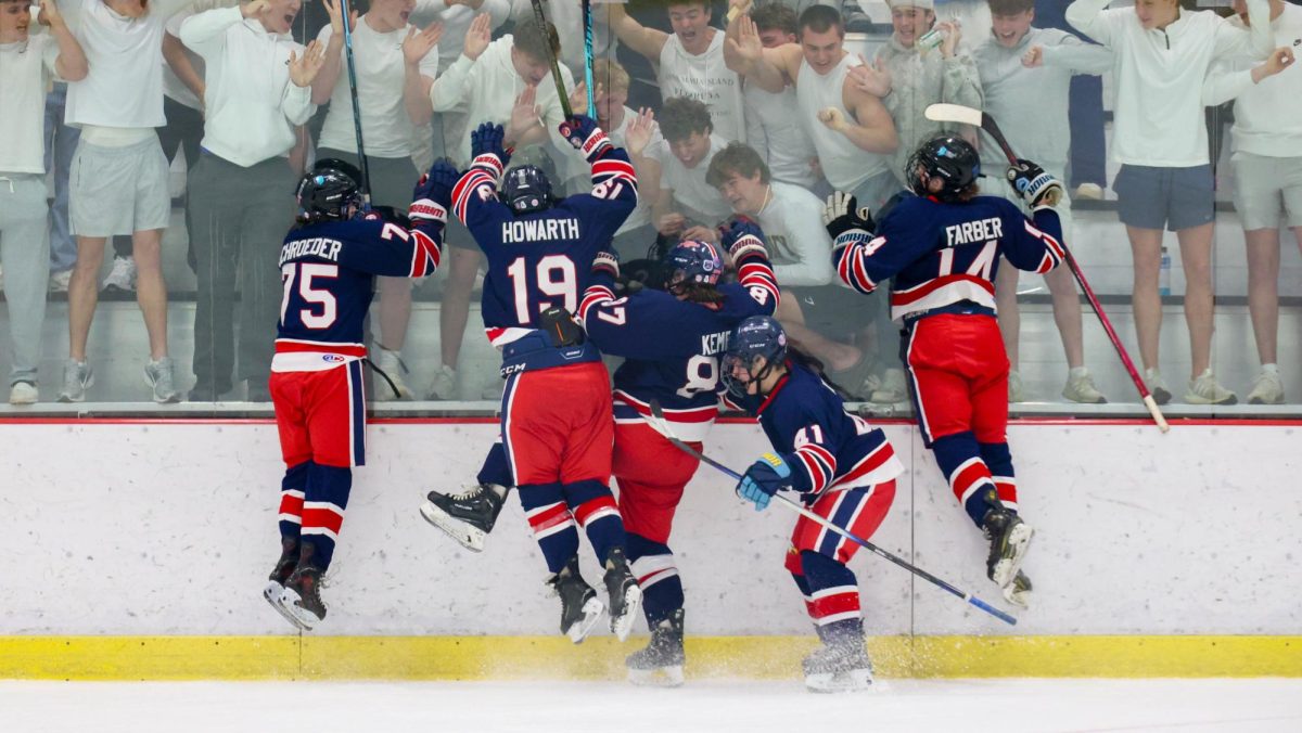 Liberty players jump on the glass in front of the student section after Lucas Kempf (12) scored the first goal of the game.