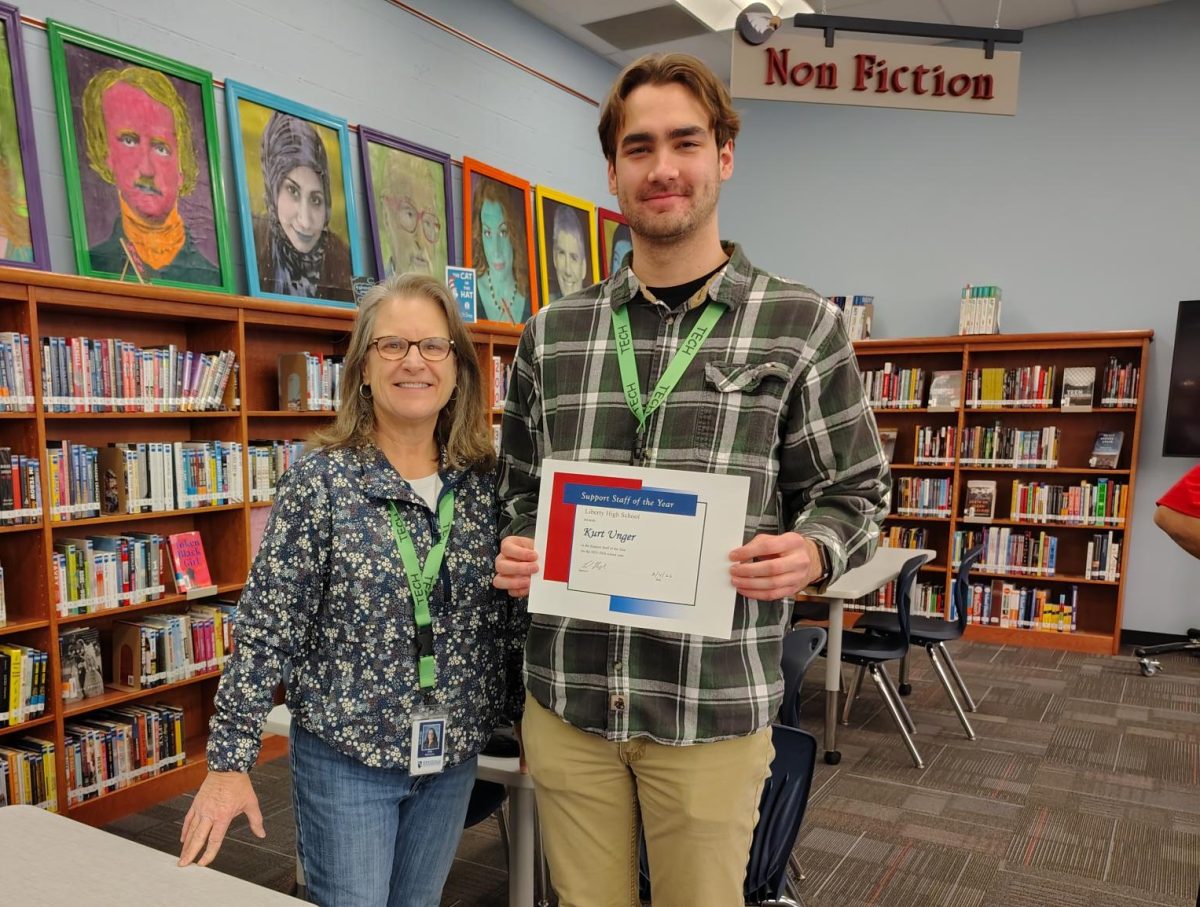 Mr. Kurt Unger accepts the award he has been given for achieving Support Staff of the Year. Also pictured is Arla Monroe, director of Technology Operations for the Wentzville School District.