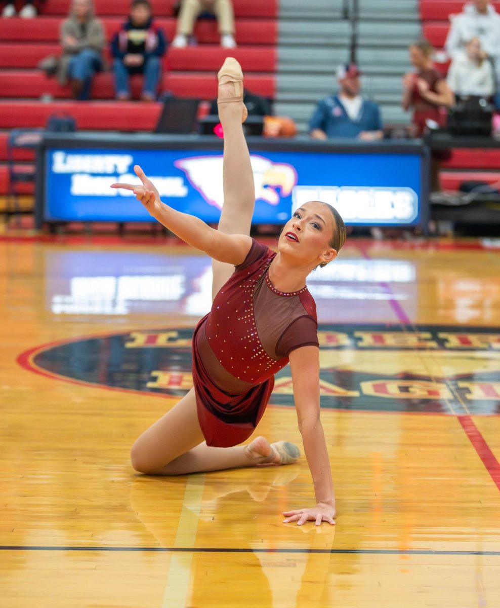 Haylee Carlson (12) hits a leg hold during the jazz routine.