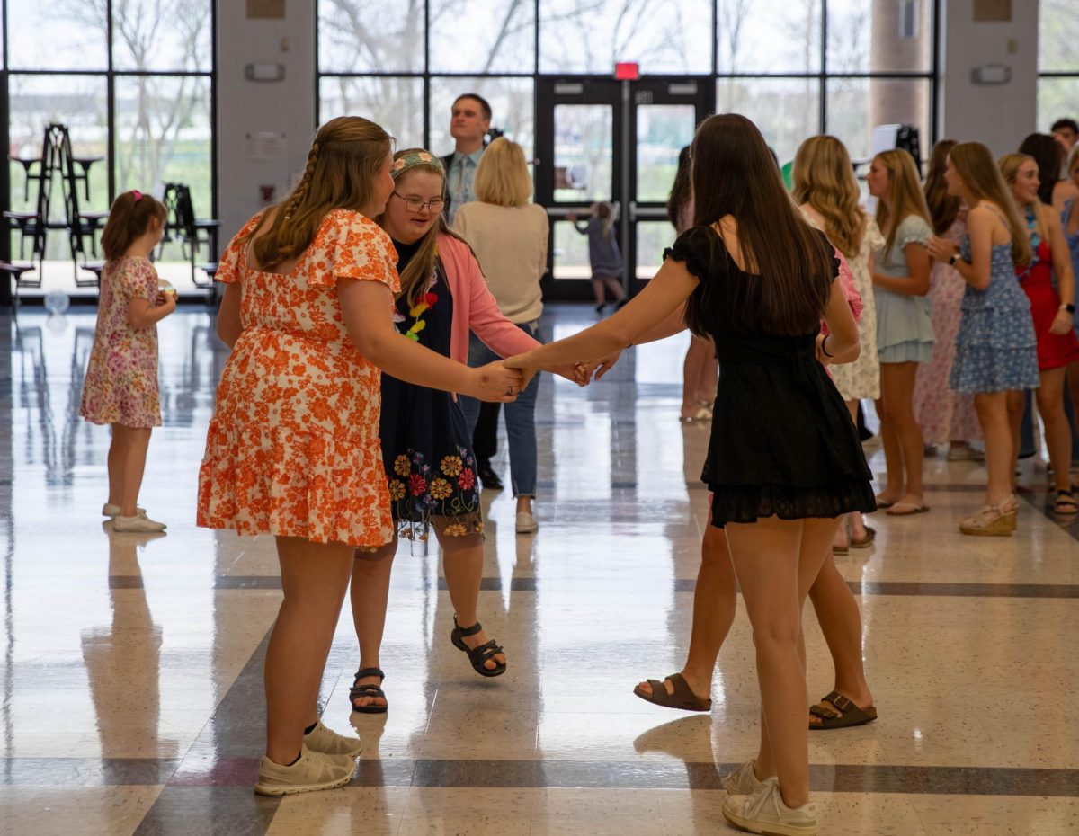 Kayla Coleman (12) and others dance in a circle.