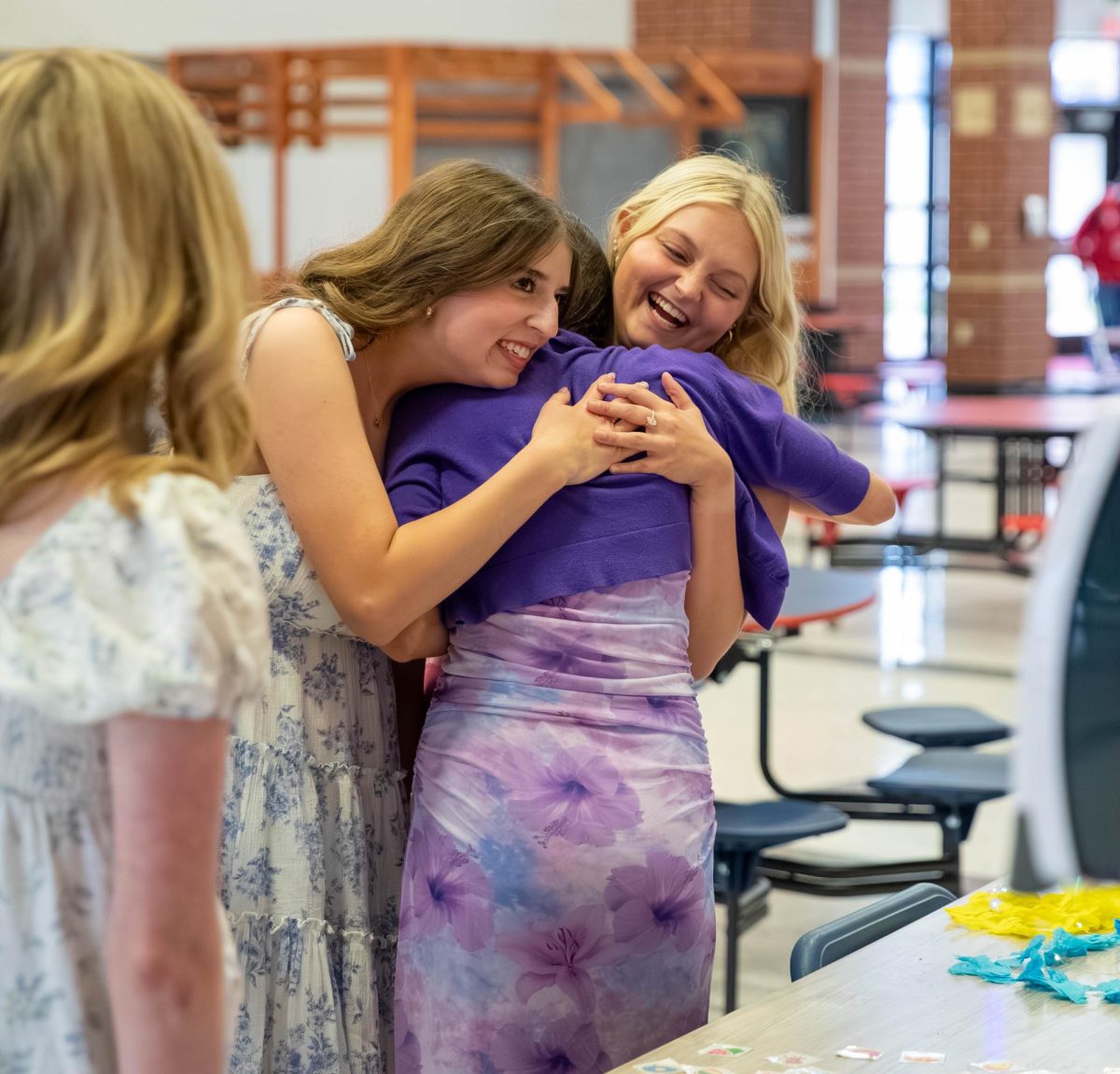 Bella Romine (12) and Kylie Richardson (12) hug their friend when they sees her at the dance. 