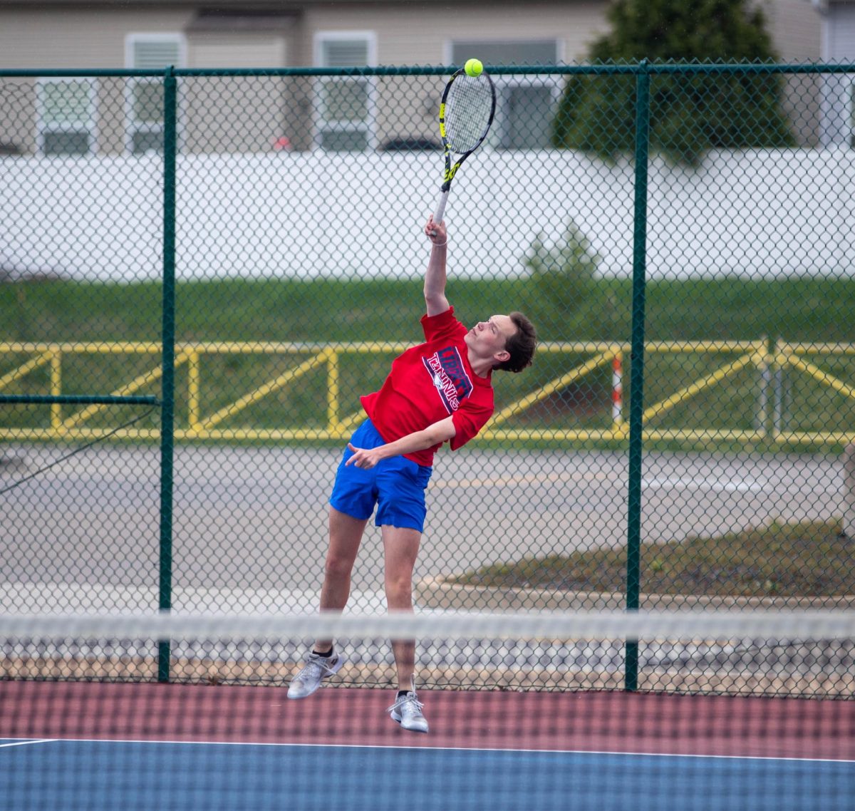 Charles Giraud (12) follows through on a shot in a match in the Show Me MO Holt/Marquette Tournament on April 10.