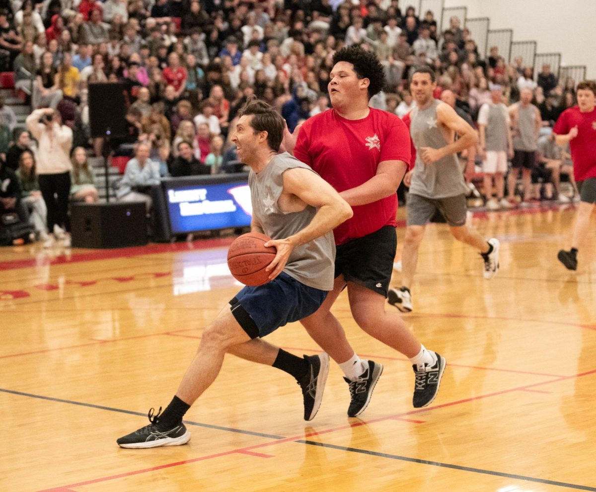 Brett Hendricks eludes a defender as he goes up for a layup in the staff's 53-40 victory in the 2025 Swofford game. 
