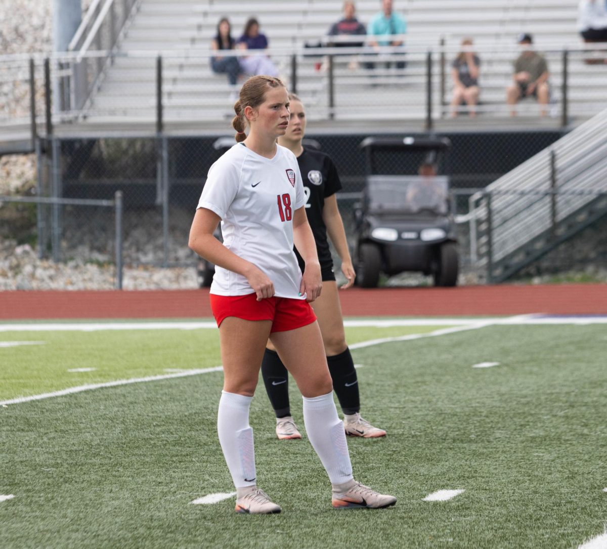 Sydney Shuster (9) waits for the ball as she stands next to a defender. 