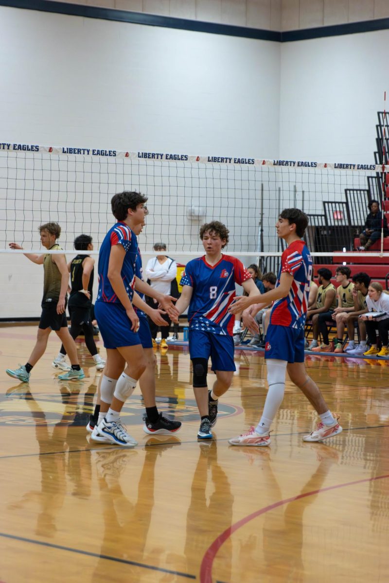 Nicholas Hostetter (11), Brody Breen (11), William Quinney (10) and James Siterlet (11) share high-fives after scoring.