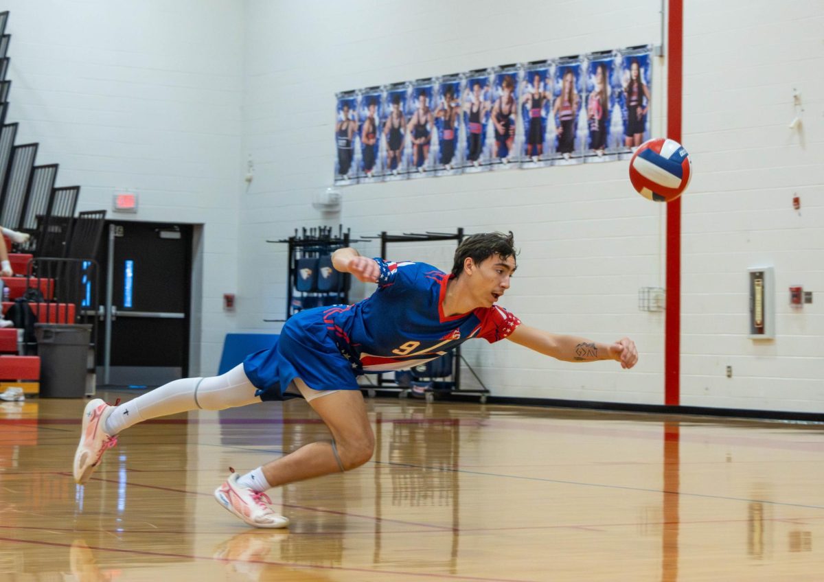 Brody Breen (11) dives to save an out of system ball to continue the play.