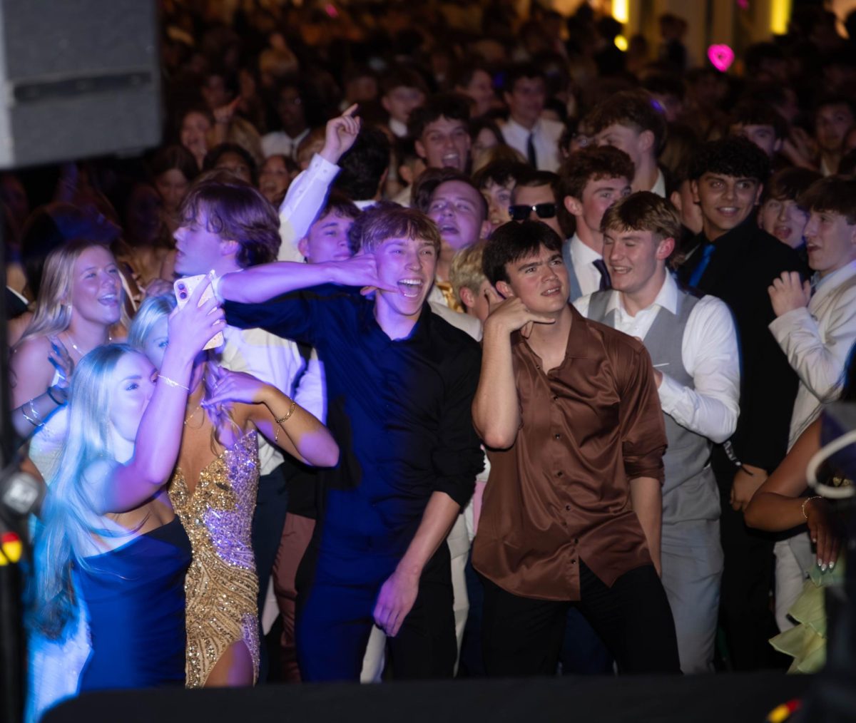 Chandler Hirtz (12) and Sully Thornton (12) put fake phones up to their ears.