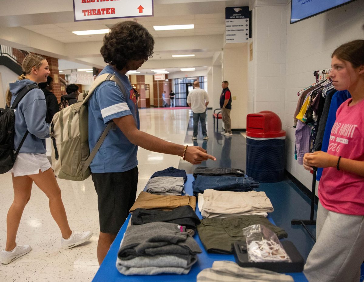 Aarush Sunil Viswanathan (11) looks through the donated clothing looking for something to swap.