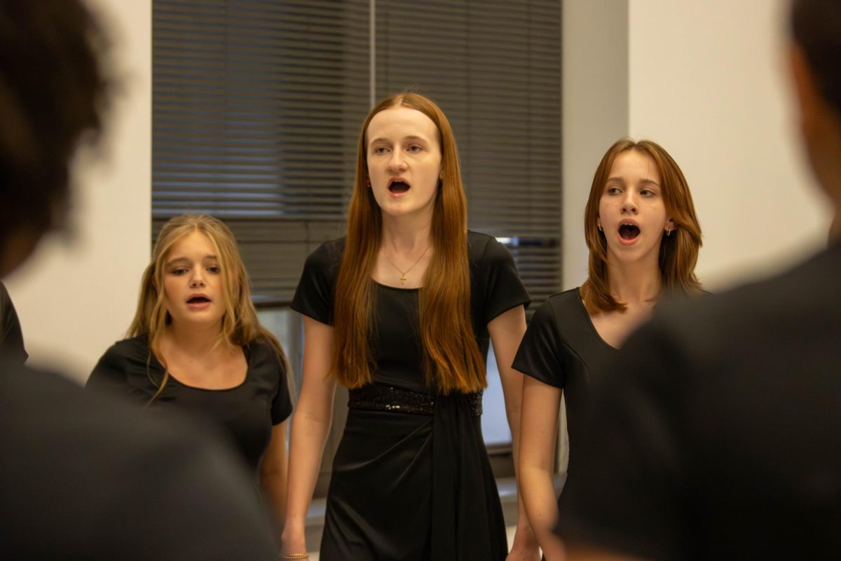 Brynn. Galliher is singing with her fellow Choir peers at their Fall Concert.