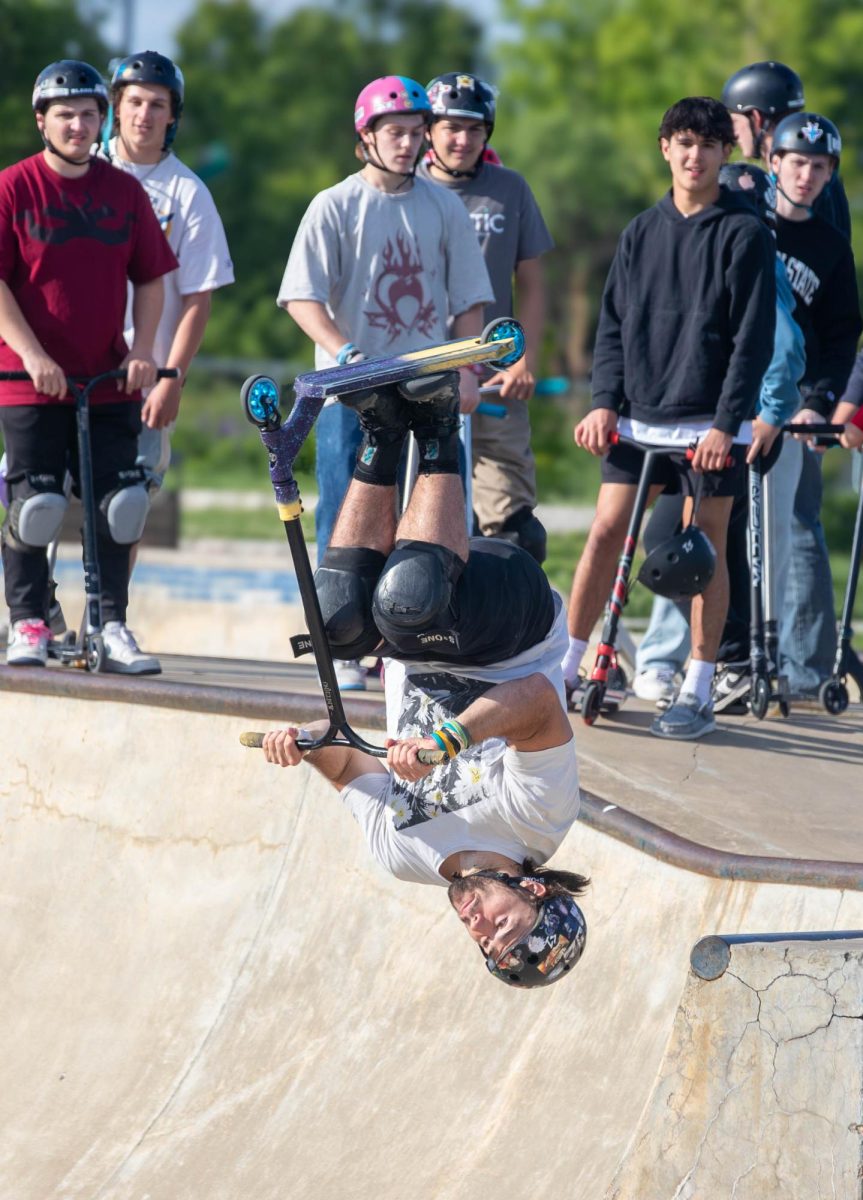 Sam Morris, a professional for Fuzion Scooters, does a backflip at Kinetic Park.