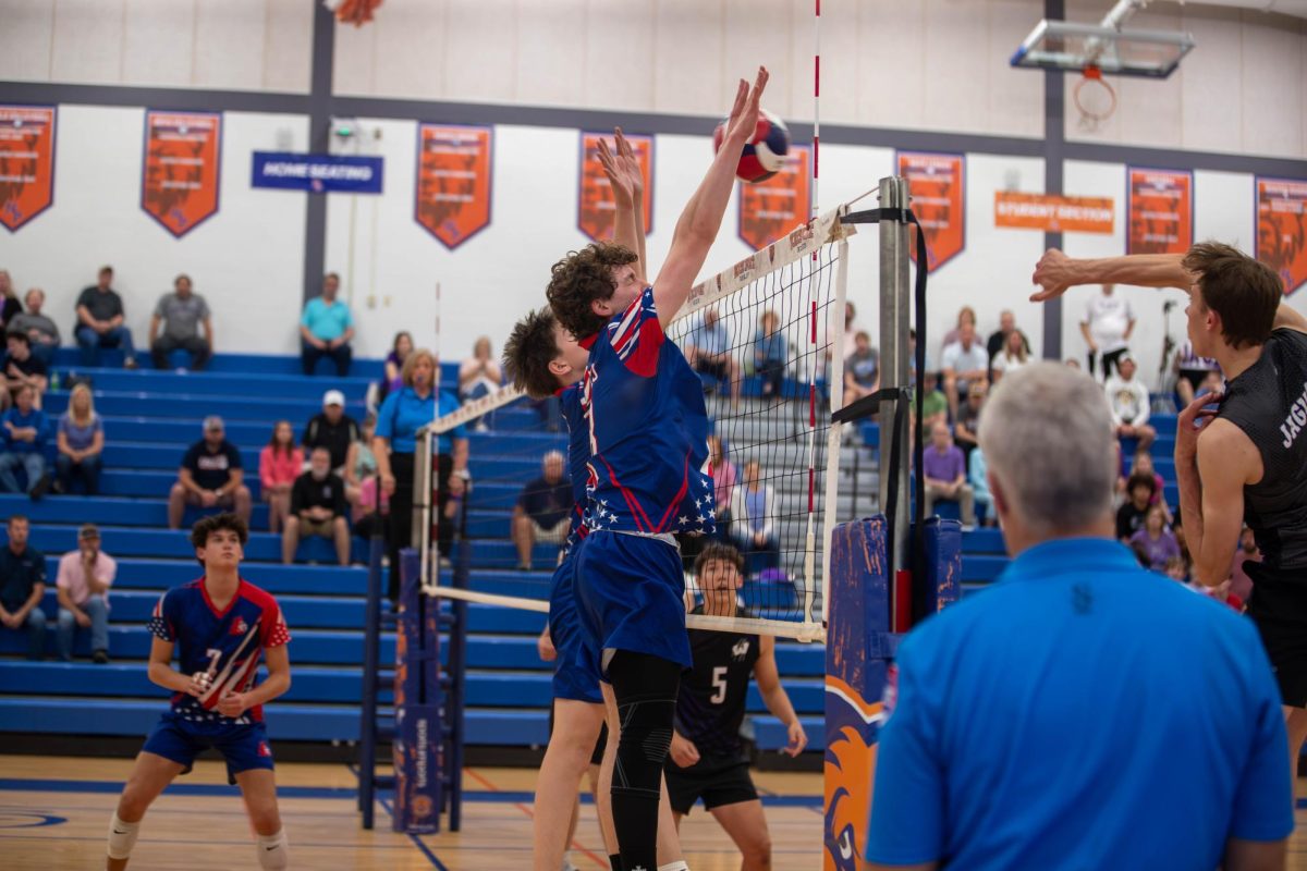 Beckham Laboube (9) and Nicholas Hostetter (11) going for a block against Fort Zumwalt West's outside hitter.