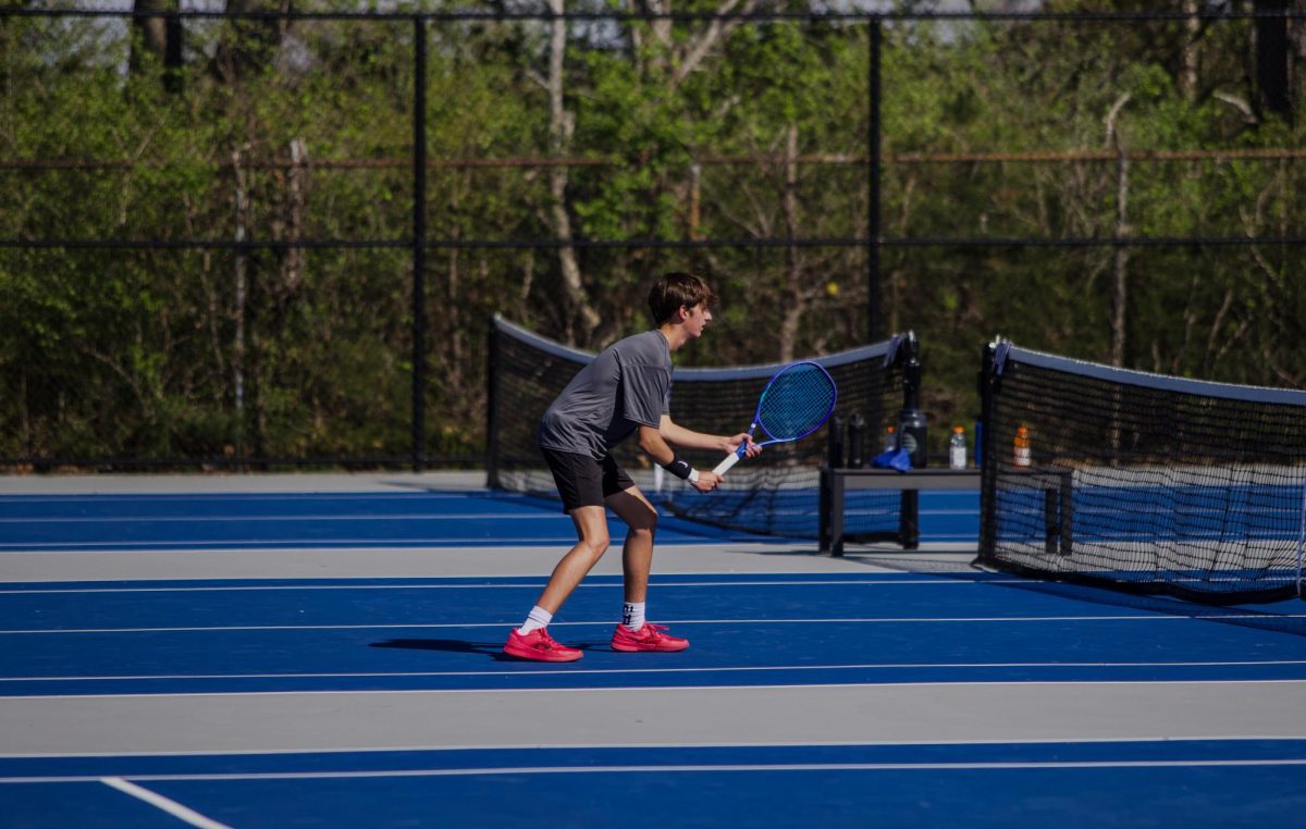 Ryan Lankston (11) plays solo in a tennis match.