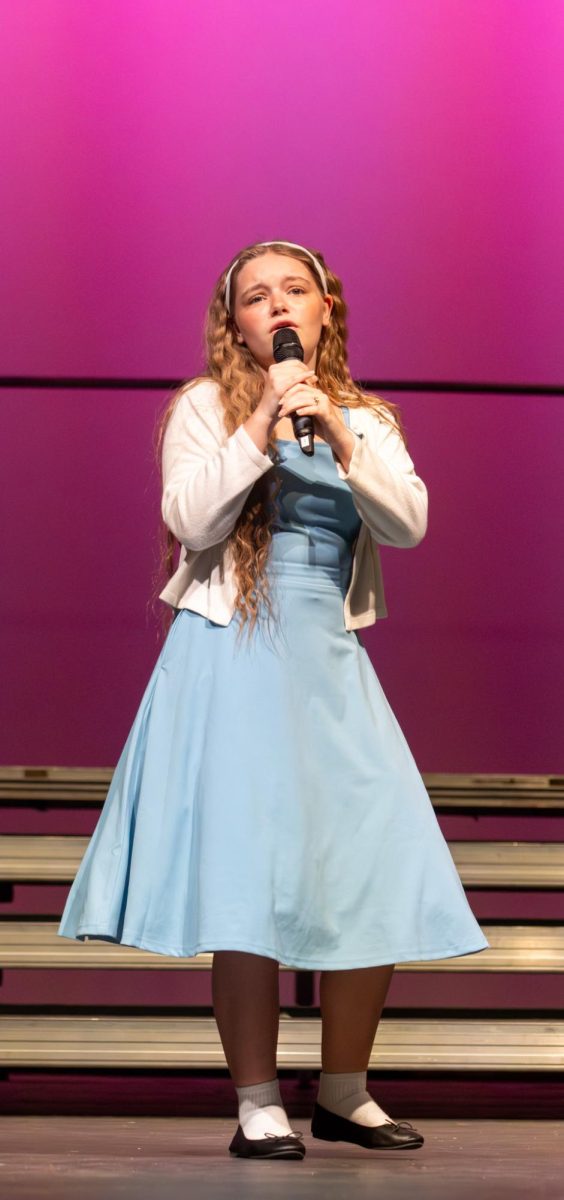 Liberty Franciskato (11) sings "Hopelessly Devoted to You" in a solo. 