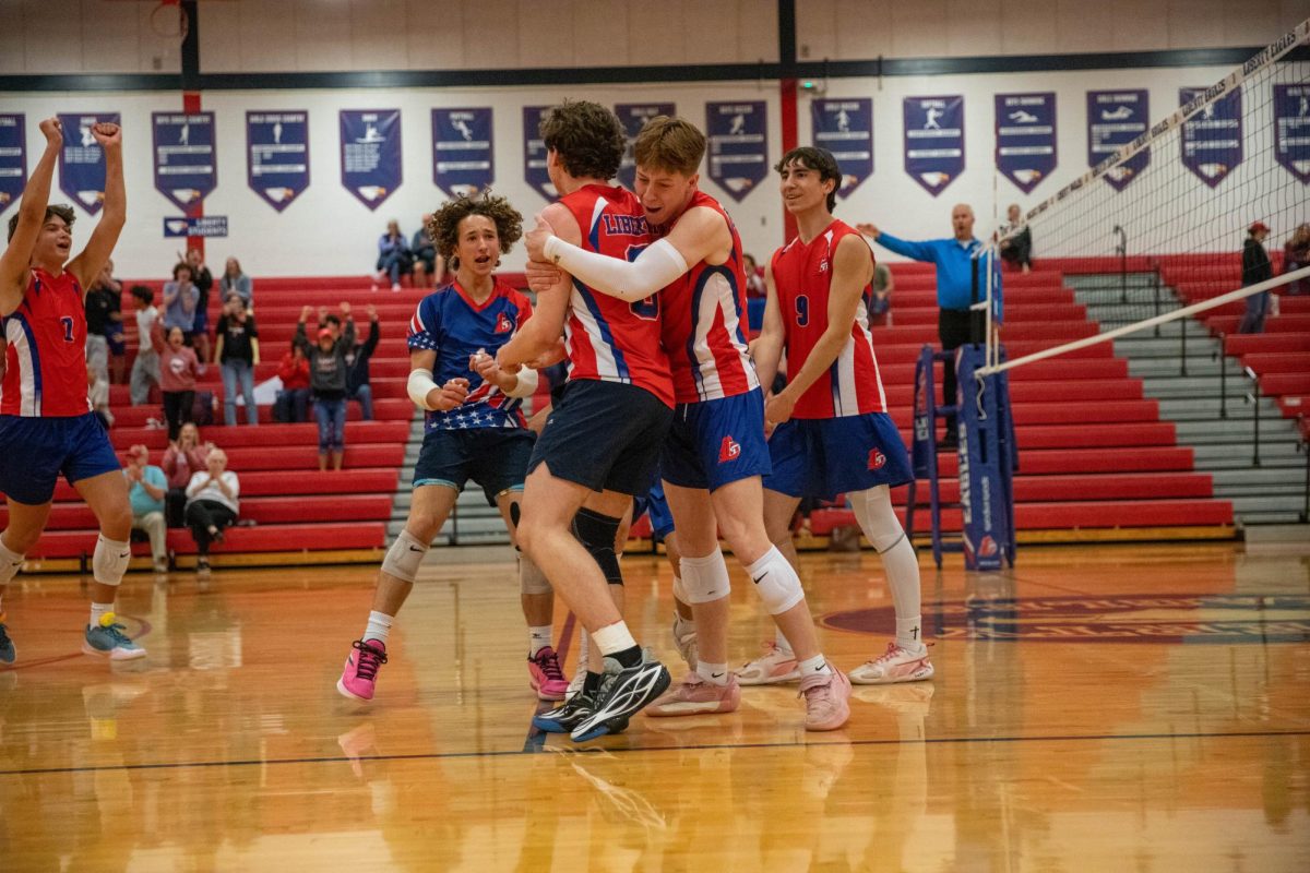 The varsity boys volleyball celebrate their reverse sweep against Lutheran St. Charles earlier this season. 