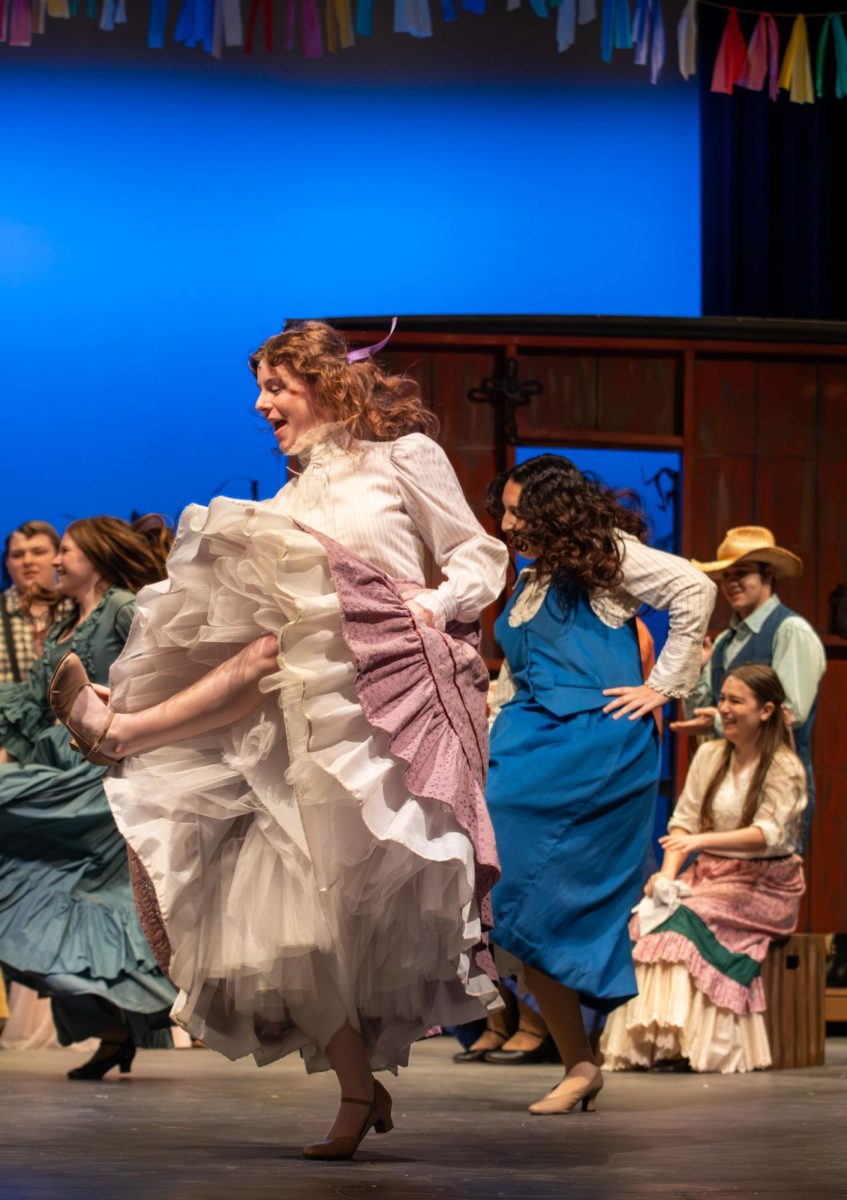 Marley Higlen (11), who played the rambunctious Ado Annie, dances during the song "The Farmer and the Cowman." The cast was thrilled to learn the steps for the number from choreographer Cam Bopp.