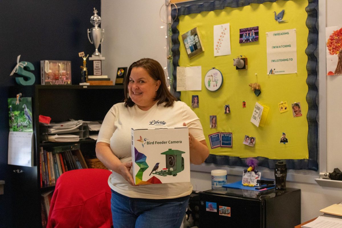 ELA teacher Meredith Steinbruegge showcases a gift she won during Teacher Appreciation Week. 
