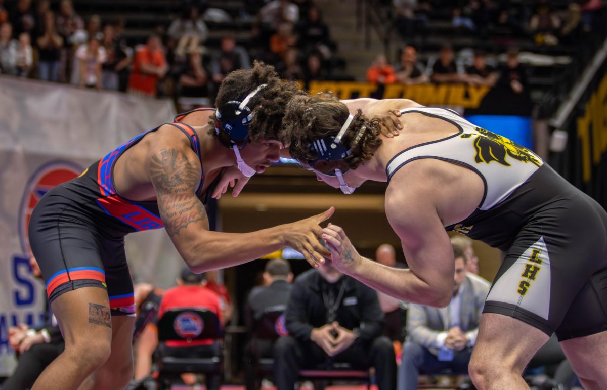 Maddoxx Jones (12) grasps his opponent from Lafayette during his state match. 