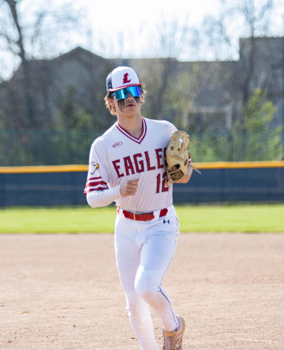 Kaelen Homar (10) jogs on the field during a baseball game. 