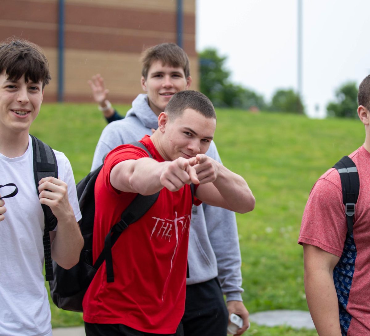 Paxton Hughes (12) points at the camera as he walks on the bridge.