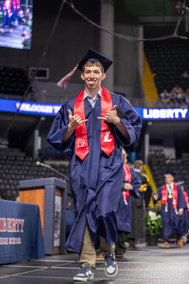 Garrett Matlock sticks his tongue out and gives the shaka sign with his hands.