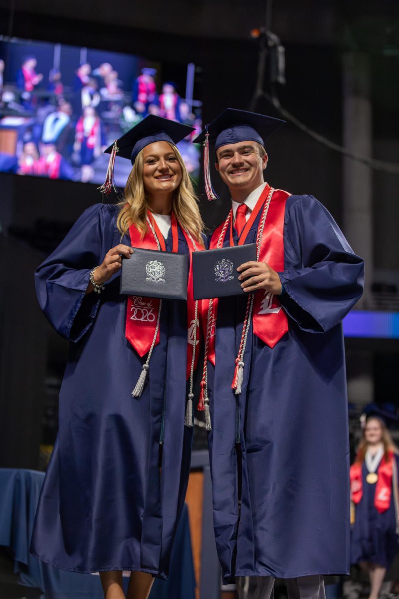 Twins Charlotte and Sullivan Thornton pose together after receiving their diplomas.
