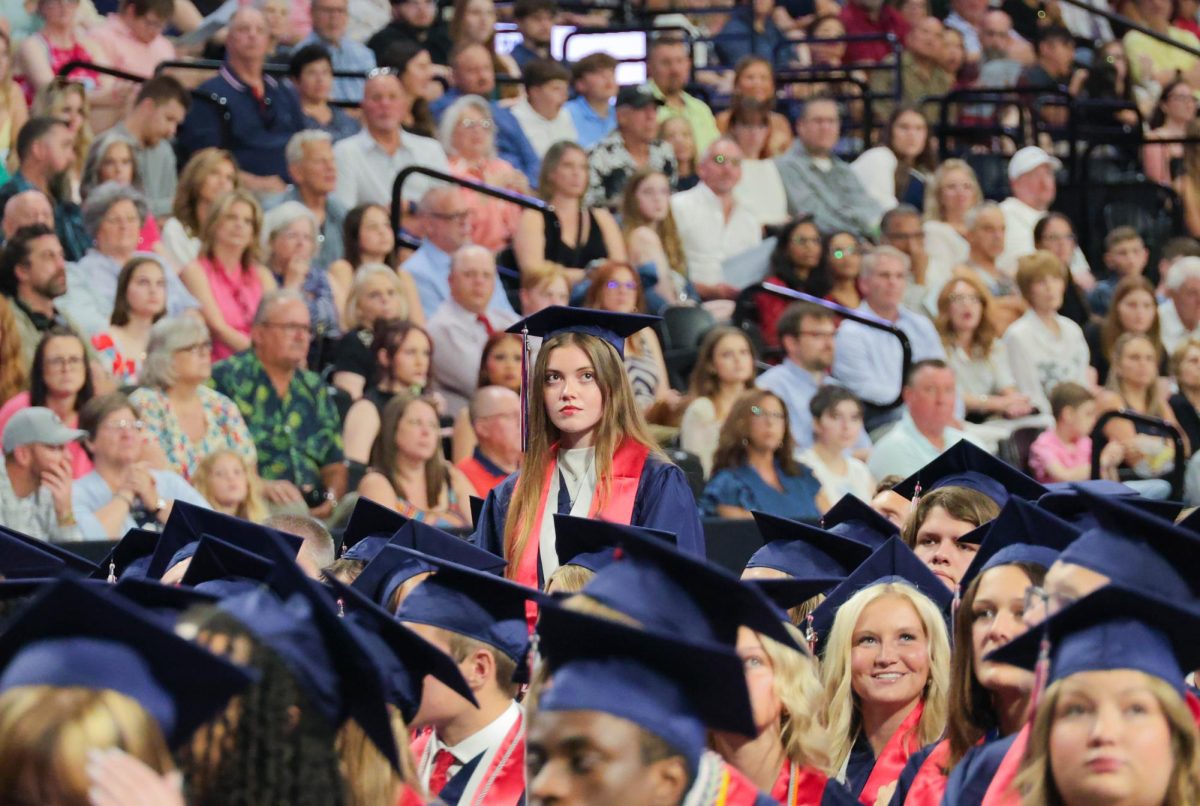 Marissa Jackson stands for graduating with an associate's degree from St. Charles Community College.