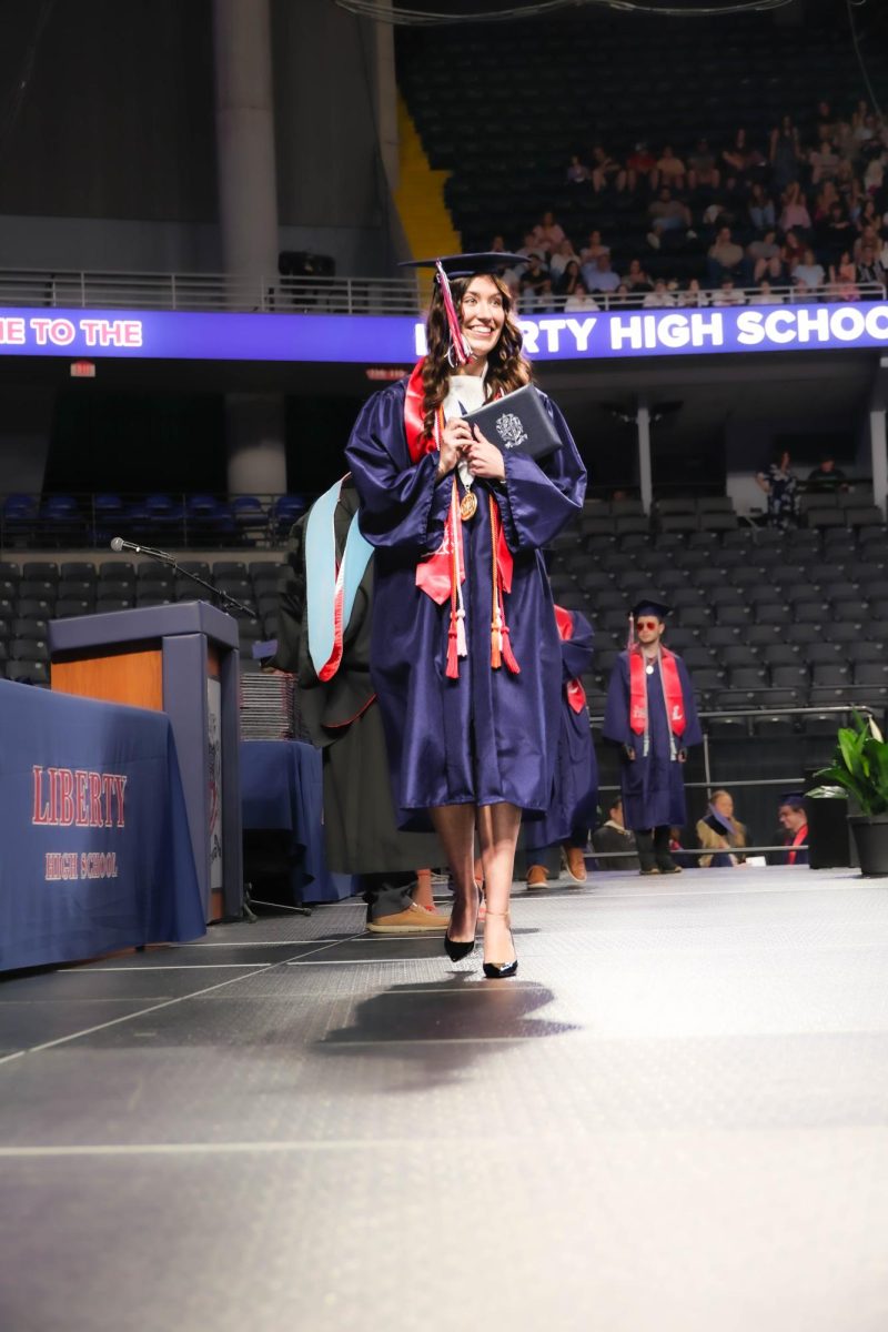 Ryleigh Christy smiles to the crowd after receiving her diploma.