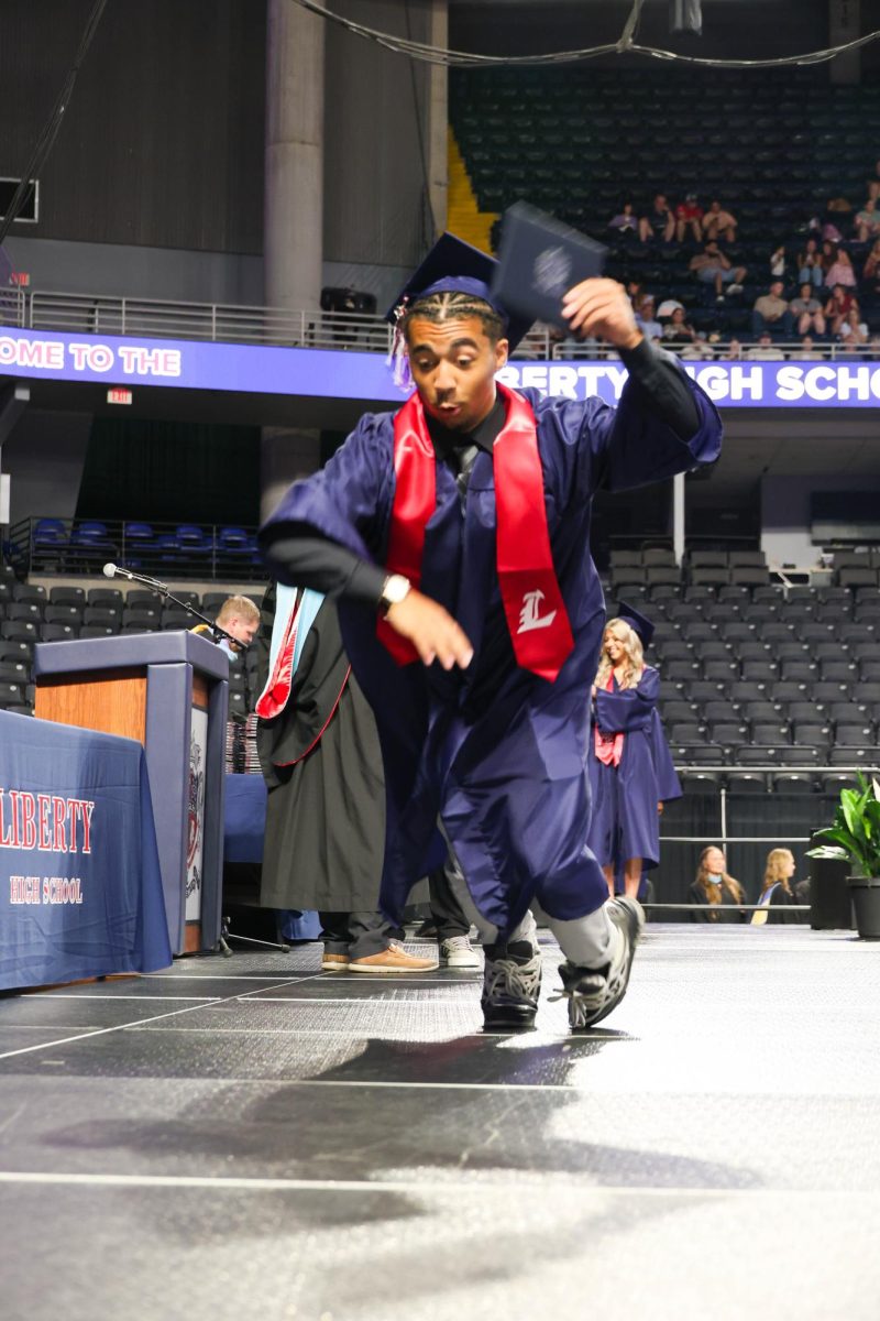 Jaylen Mack fake falls after receiving his diploma and shaking hands with Dr. Nelson.